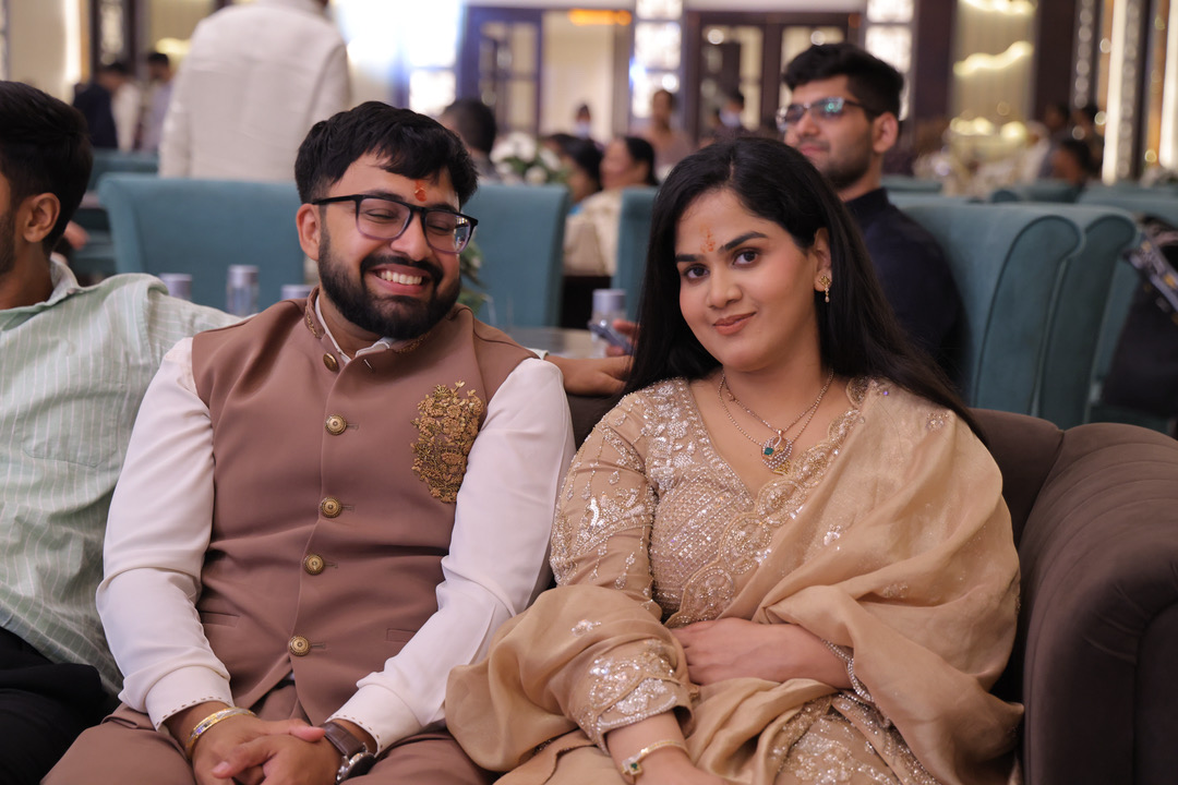 A candid moment of the couple sharing a laugh at the reception