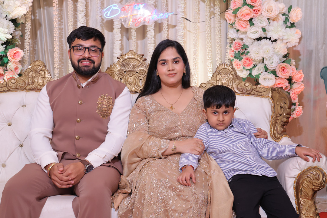 Sagrika and Maniv seated on the reception stage with family